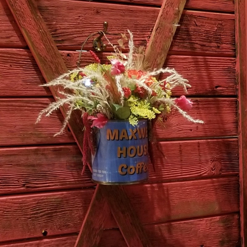 Roam Wild and Free Prop Floral Arrangment in a faux vintage coffee can.