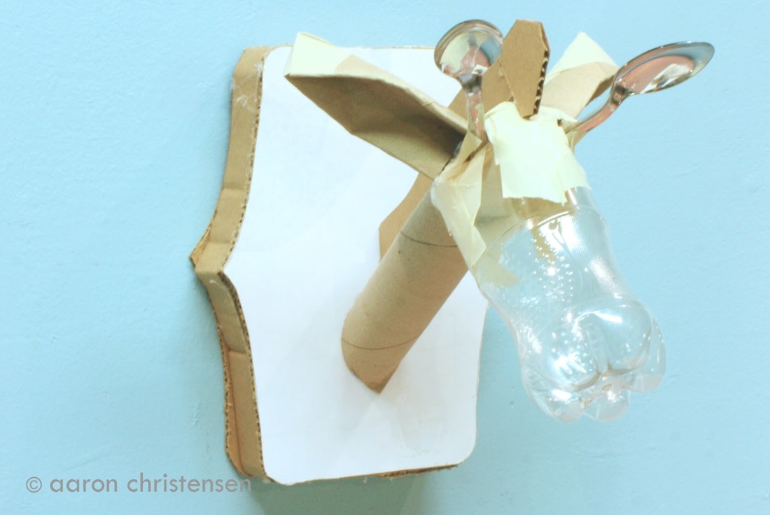 Plastic bottle, cardboard, tape and utensils become a taxidermied garaffe.