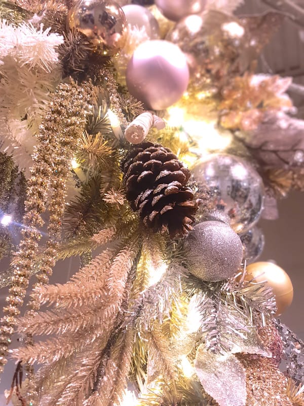 Holiday trim of mixed metals, rose gold, copper and more adorn a ...